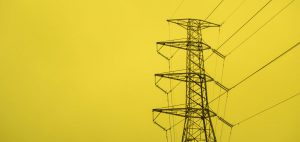 Electricity pylon with a yellow background