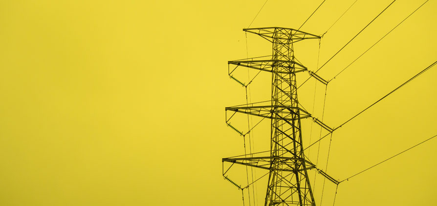 Electricity pylon with a yellow background